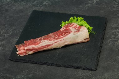 Tahtanın üzerinde çiğ domuz pastırması salata ve kekik servis edildi.