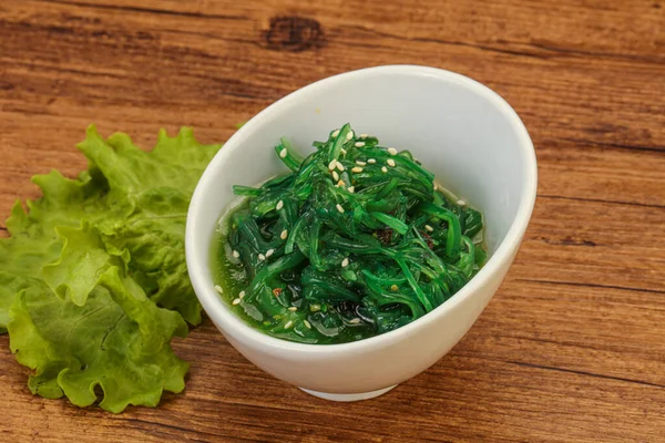 Green Chuka Seaweed Salad Isolated on White Background Top View. Wakame Sea Kelp Salat, Chukka Sea Weed, Healthy Algae Food