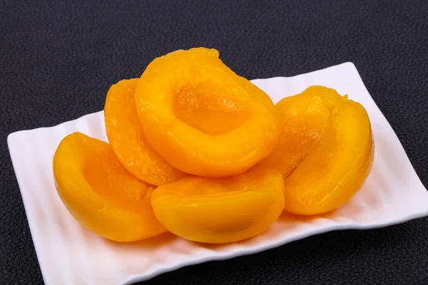 Sweet marinated peach slices in the bowl