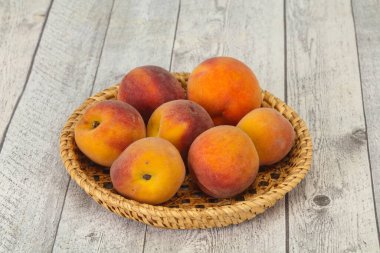 Tahta sepetteki olgun şeftali yığını