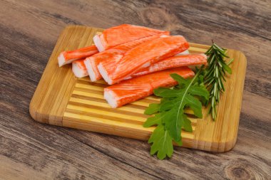 Ahşap tahtanın üzerinde yengeç çubuğu surimi