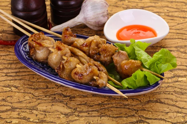 Chicken skin skewer with chili sauce