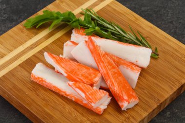 Ahşap tahtanın üzerinde yengeç çubuğu surimi