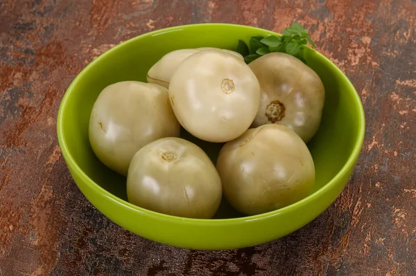 Pickled green tomatoes in the bowl