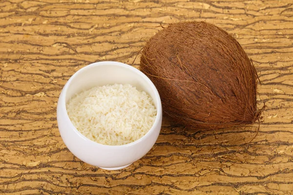 Coconut shredded chip with nut over wooden background