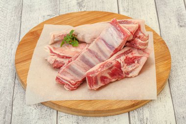 Raw lamb ribs served rosemary for cooking clipart