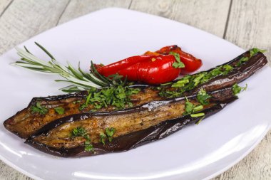 Dolmalık biberli ızgara patlıcan yeşil otlar ve baharatlar servis edilir.