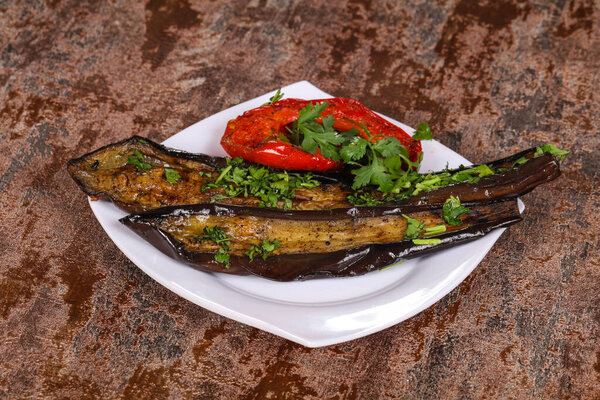 Grilled eggplant with bell pepper served green herbs and spices