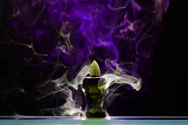 Aromatic cone smoldering in a ceramic stand