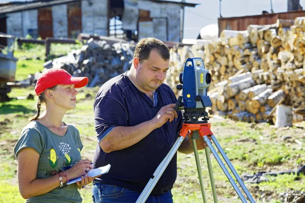 Archaeologists record the coordinates measured using a total station