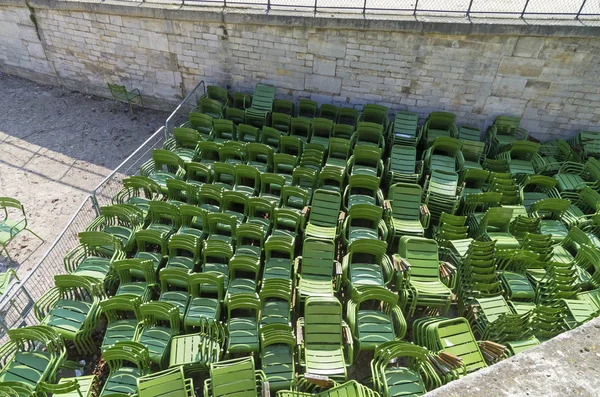 Storage of park furniture - green iron chairs.