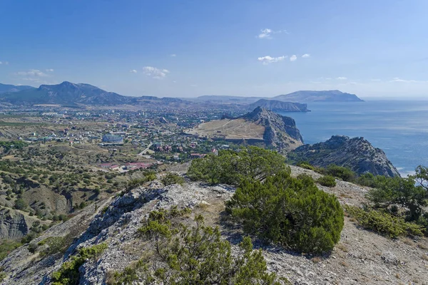 View from the coastal mountains to the resort town of Sudak. Crimea. Sunny day in September.