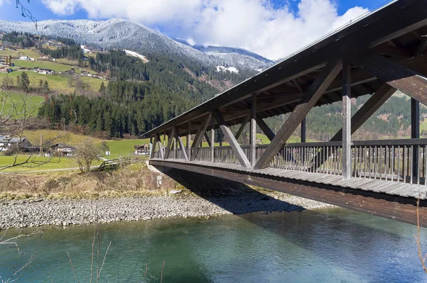 Wooden foot bridge over the Ziller River. Tyrol, Austria.
