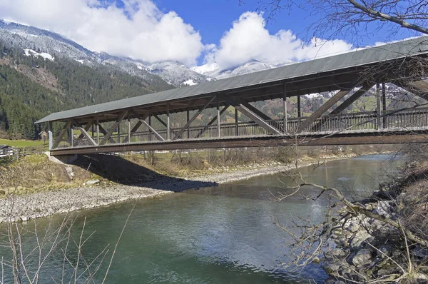 Wooden foot bridge over the Ziller River. Tyrol, Austria.