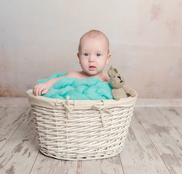 Funny little baby sitting in basket — Stock Photo, Image