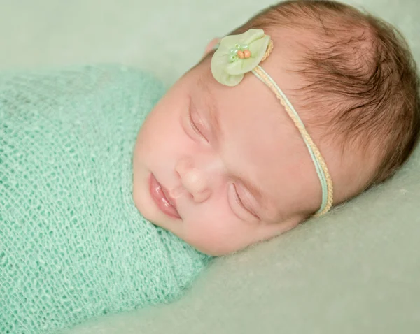 Beautiful newborn girl in green — Stock Photo, Image