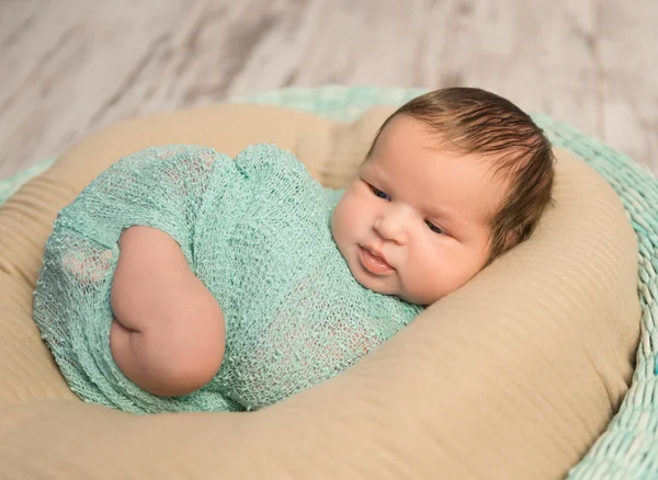 Wrapped newborn with bare foot — Stock Photo, Image