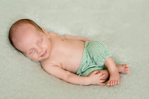 Sleeping newborn baby in green pants — Stock Photo, Image