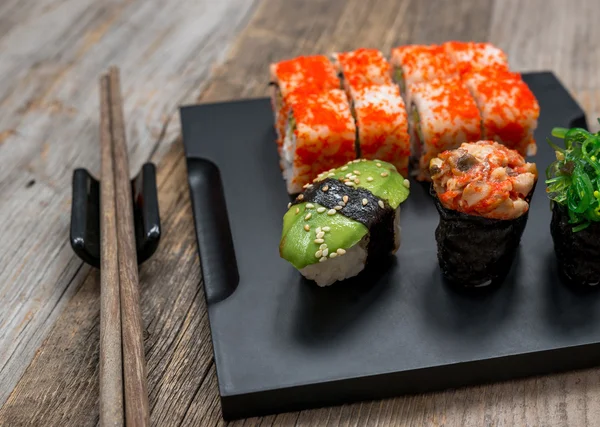 Set of sushi and rolls with chopsticks — Stock Photo, Image