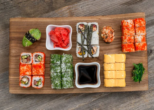 Set of sushi and rolls with chopsticks — Stock Photo, Image