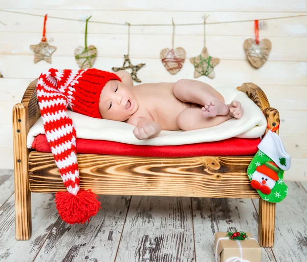 Sleeping newborn baby in christmas decorations — Stock Photo, Image