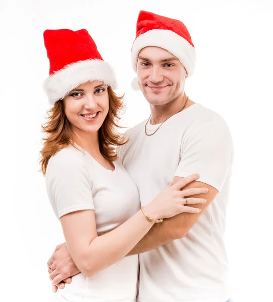 Young couple in red santa hats — Stock Photo, Image