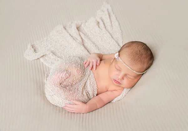 Lovely sleeping infant wrapped in gray warm diaper — Stock Photo, Image