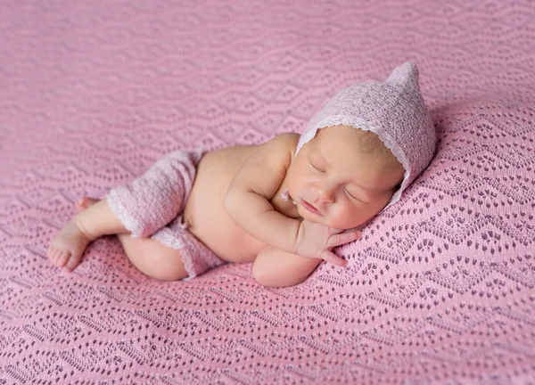 Lovely newborn in pink hat and panties — Stock Photo, Image