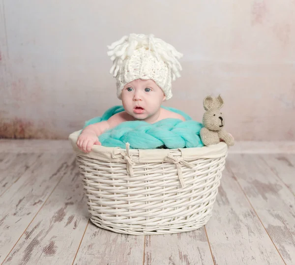 Funny little baby sitting in basket — Stock Photo, Image