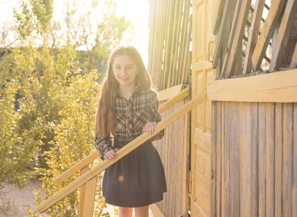 Smiling little girl on wooden porch — Stock Photo, Image