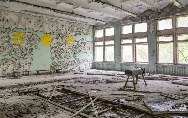 ruined school gym with sports equipment remains in Pripyat