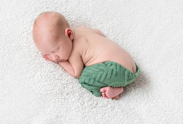 Sweet sleeping baby on white blanket in green panties — Stock Photo, Image