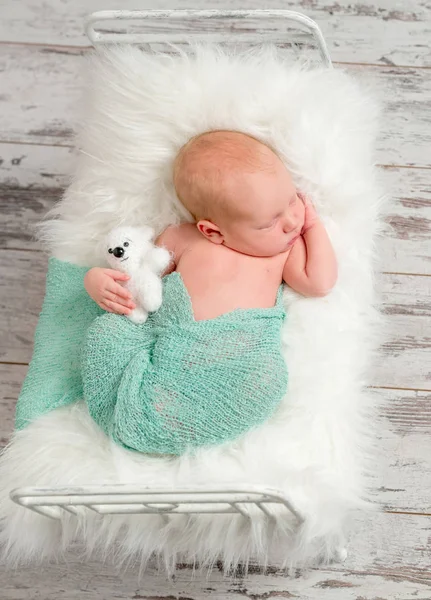 Nouveau-né dormant sur lit bébé avec couverture douce blanche — Photo