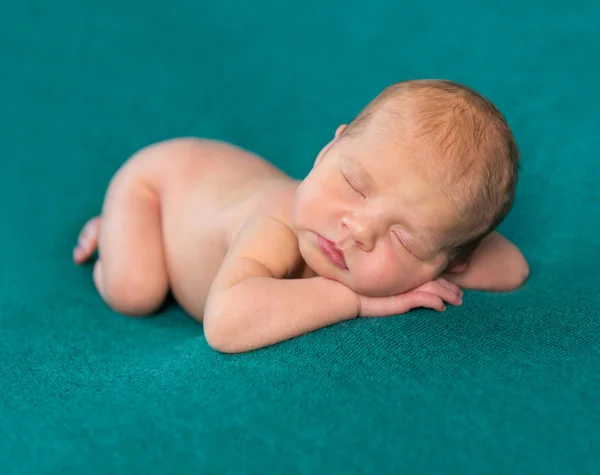 Sweet newborn sleeping on stomach and hands with headband — Stock Photo, Image