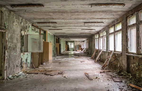 Gloomy school corridor with debris in Pripyat — Stock Photo, Image
