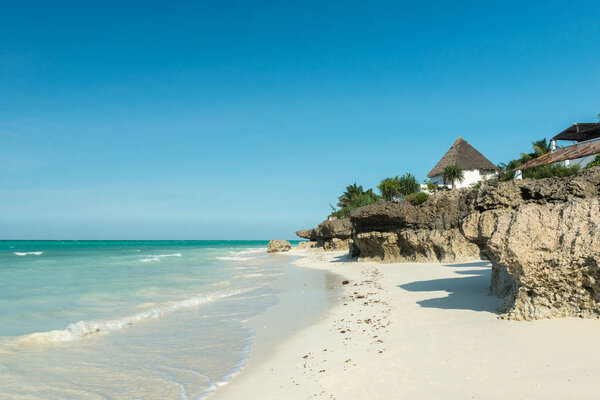 beautiful seascape with thatched houses on Zanzibar beach