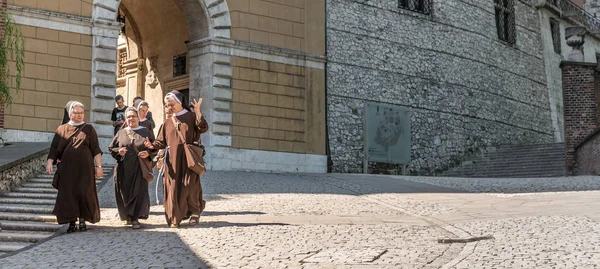 Gruppe weiblicher Mönche spaziert durch die Innenstadt von Krakau — Stockfoto