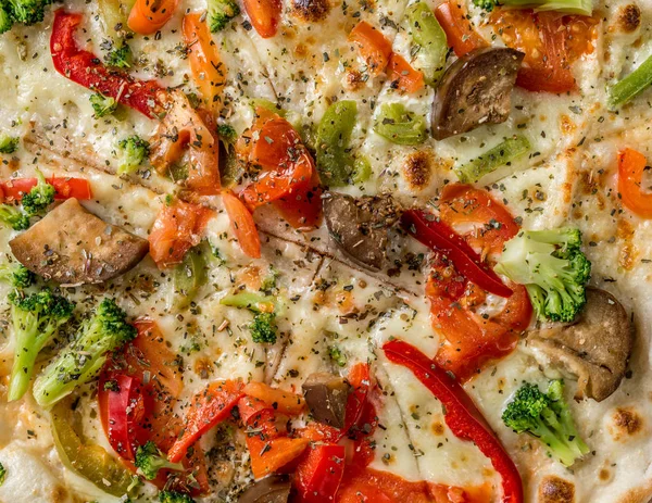 Hot steaming pizza with vegetables, closeup, topview