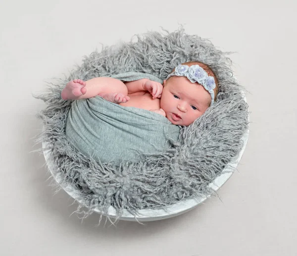 Baby in wrap crawling out of it — Stock Photo, Image