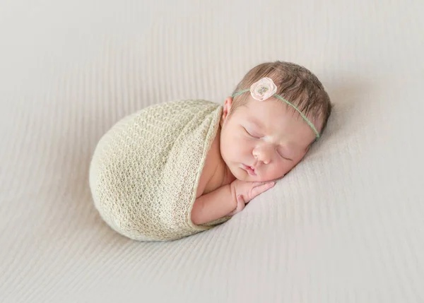 Kid napping wrapped, arm hanging out — Stock Photo, Image