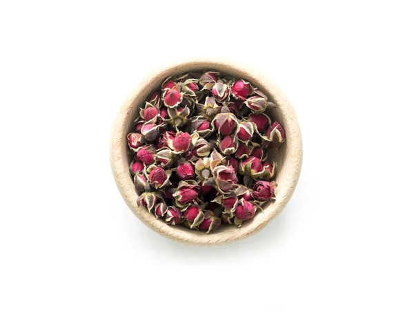 Exotické čaje, růže poupata v rustikálním mísy, topview — Stock fotografie