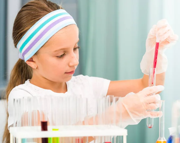 Little girl with flasks for chemistry — Stock Photo, Image