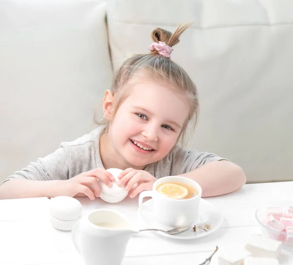 Little girl with sweets around her — Stock Photo, Image