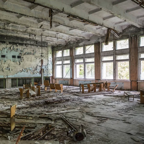 Arruinado salón de actos con escombros en la escuela Pripyat abandonada — Foto de Stock