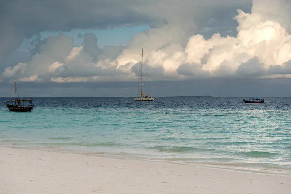 Boats with fishermen in ocean near fishing village — Stock Photo, Image