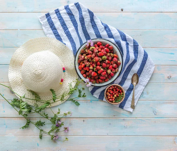 Skål med jordgubbar, randig servett, stråhatt, topview — Stockfoto