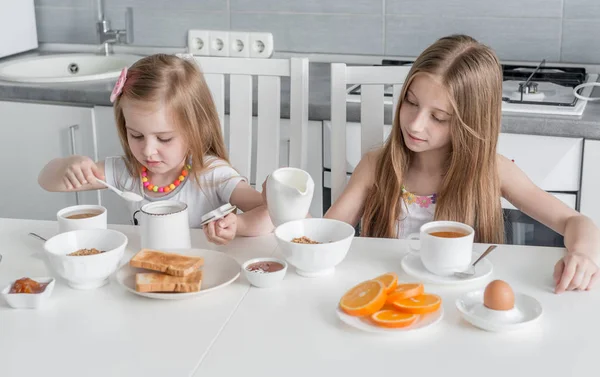 Две прекрасные сестры едят здоровый завтрак — стоковое фото
