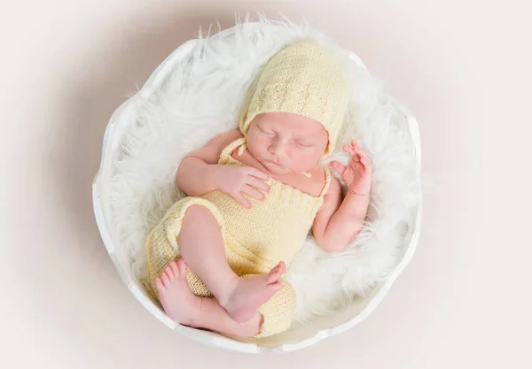 Sweet newborn baby in hat and panties sleeping on the shell — Stock Photo, Image