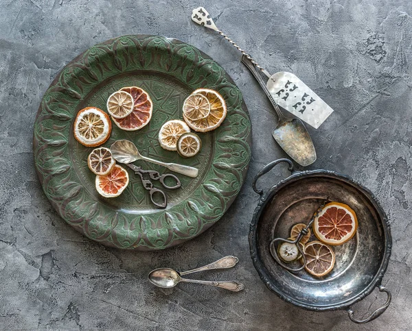 Pieces of dried oranges in vintage dishes — Stock Photo, Image