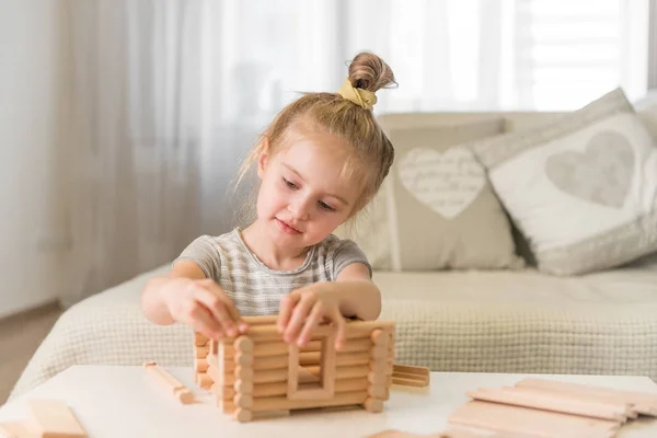 Portrait of little girl with house model — Stock Photo, Image